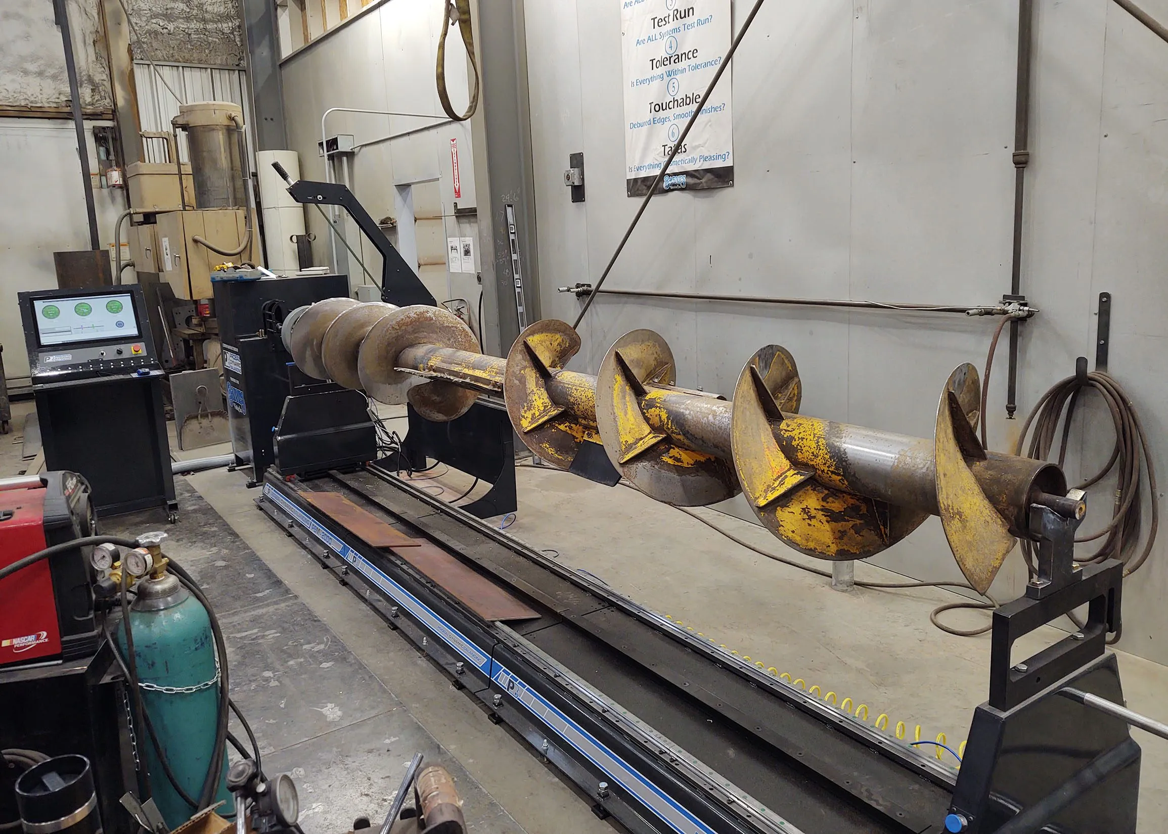 Long agricultural auger mounted on a modular ProBal auger balancing machine